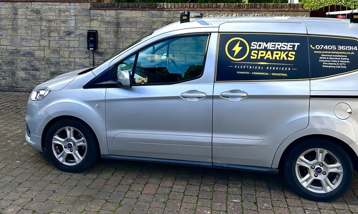The Somerset Sparks van, sign-written with the company logo and phone number 07405 361914